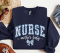 Mother Baby Nurse Sweatshirt MBU Sweater Nurse Varsity Crewneck Coquette Bow Labor and Delivery LD OB RN Postpartum Nurse Gift Sweatshirt – Warm & Stylish · Top Pick For Any Outfit