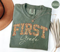 First Grade Comfort Colors Shirt Fall Autumn Teacher Team TShirts 1st Grade Tee Back to School First Grade Department Gifts Crew Graphic Tee – Fan Favorite · Must-Have Style